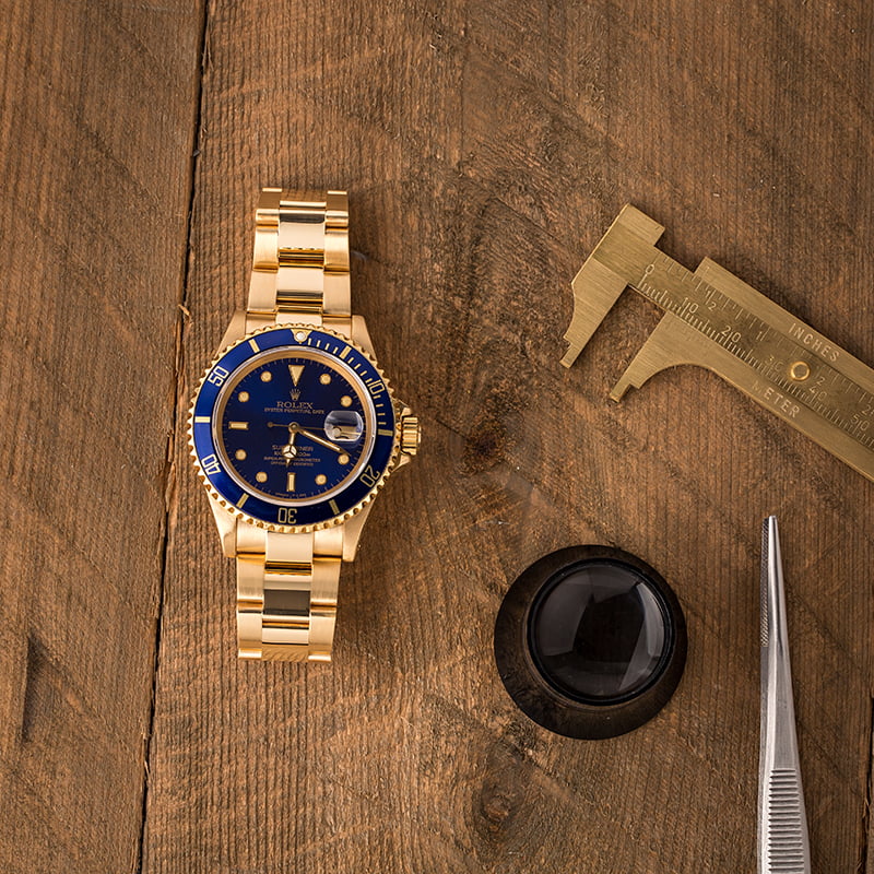 Pre Owned Rolex Submariner 16618 Blue Dial 18K Yellow Gold