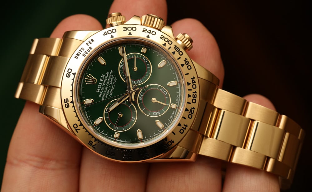 gold Rolex Daytona with green dial